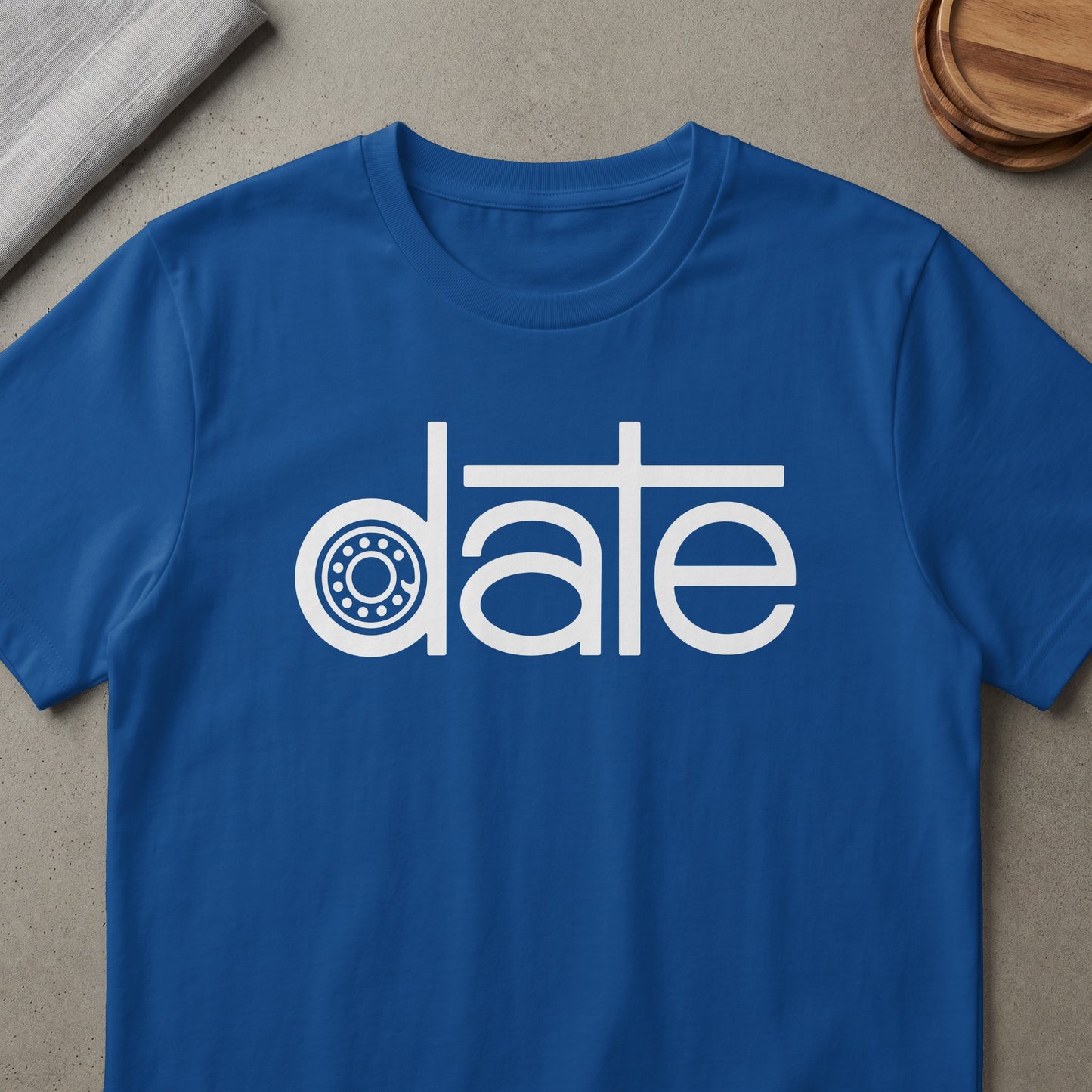 Blue t-shirt with white text "date" featuring a bearing graphic.