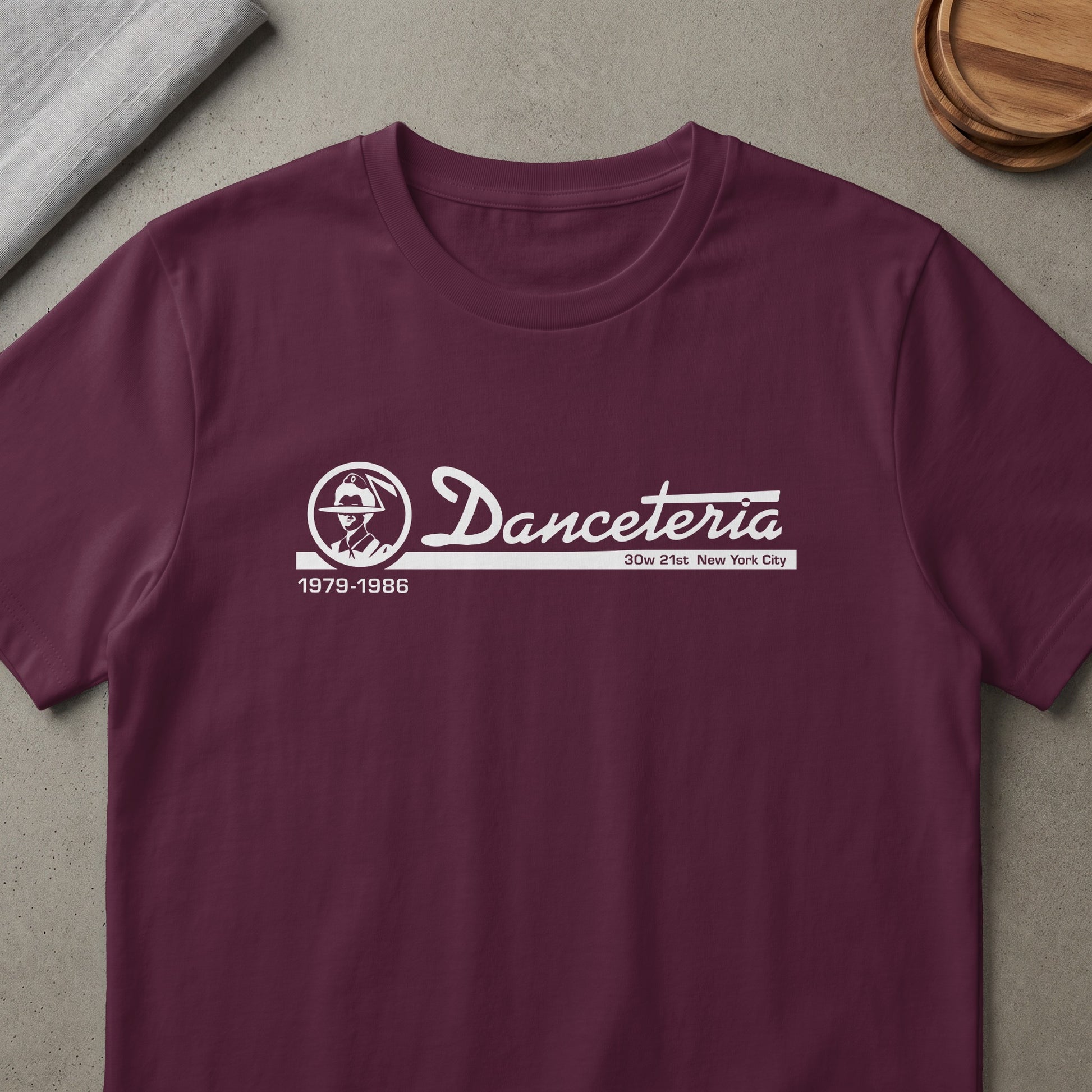 Maroon t-shirt with a white print of "Danceteria" logo, a silhouette and dates.