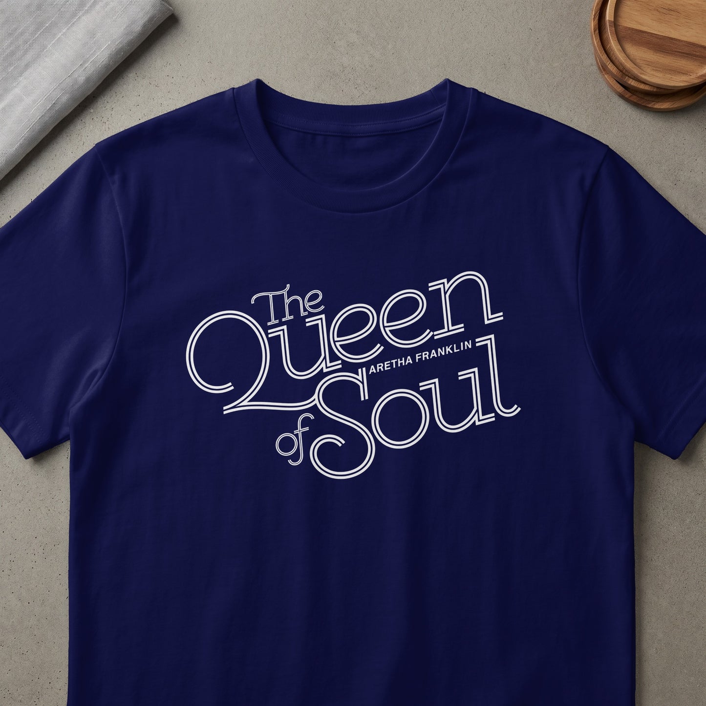Navy t-shirt with "The Queen of Soul Aretha Franklin" white text design.