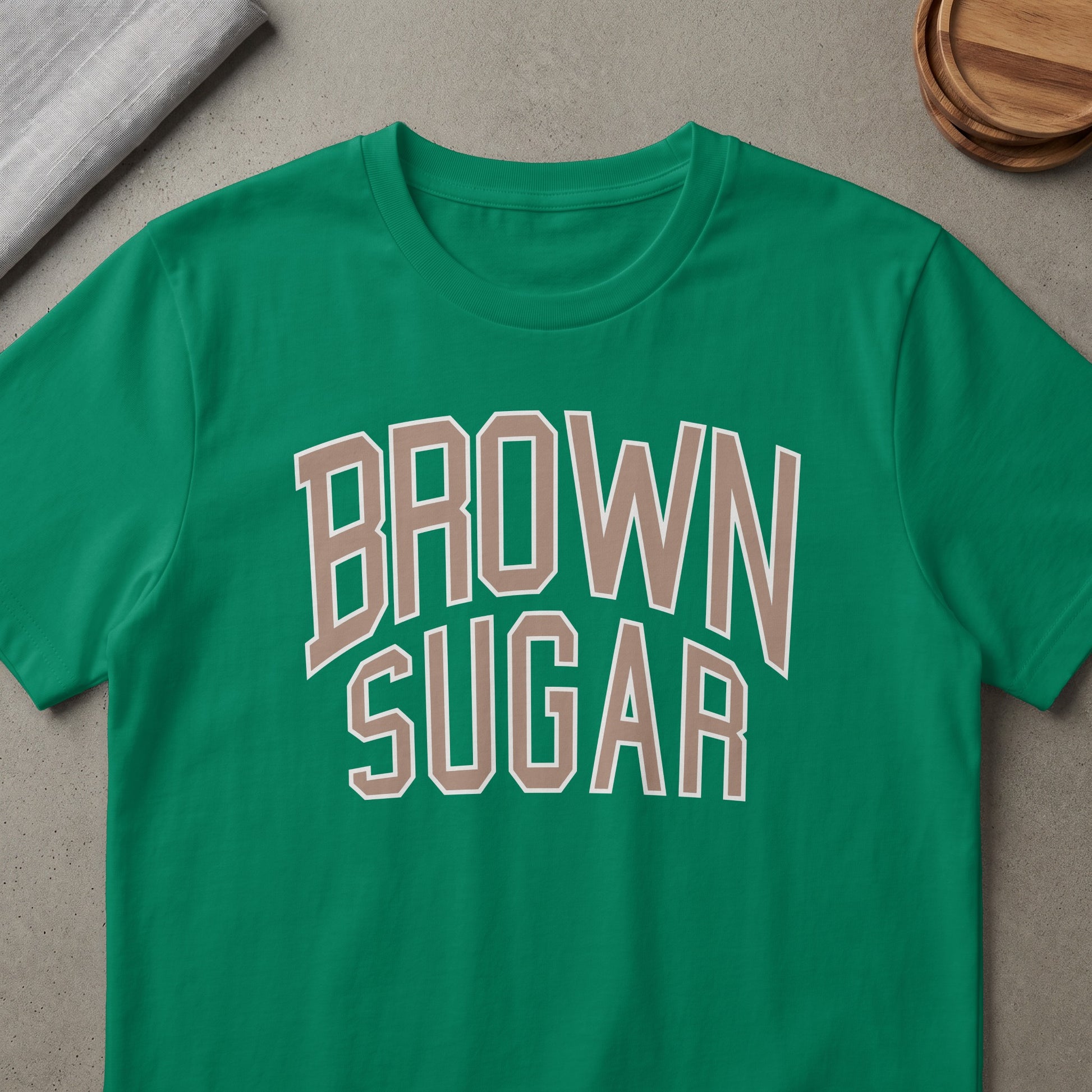 Green t-shirt with "BROWN SUGAR" text in beige and white outline.