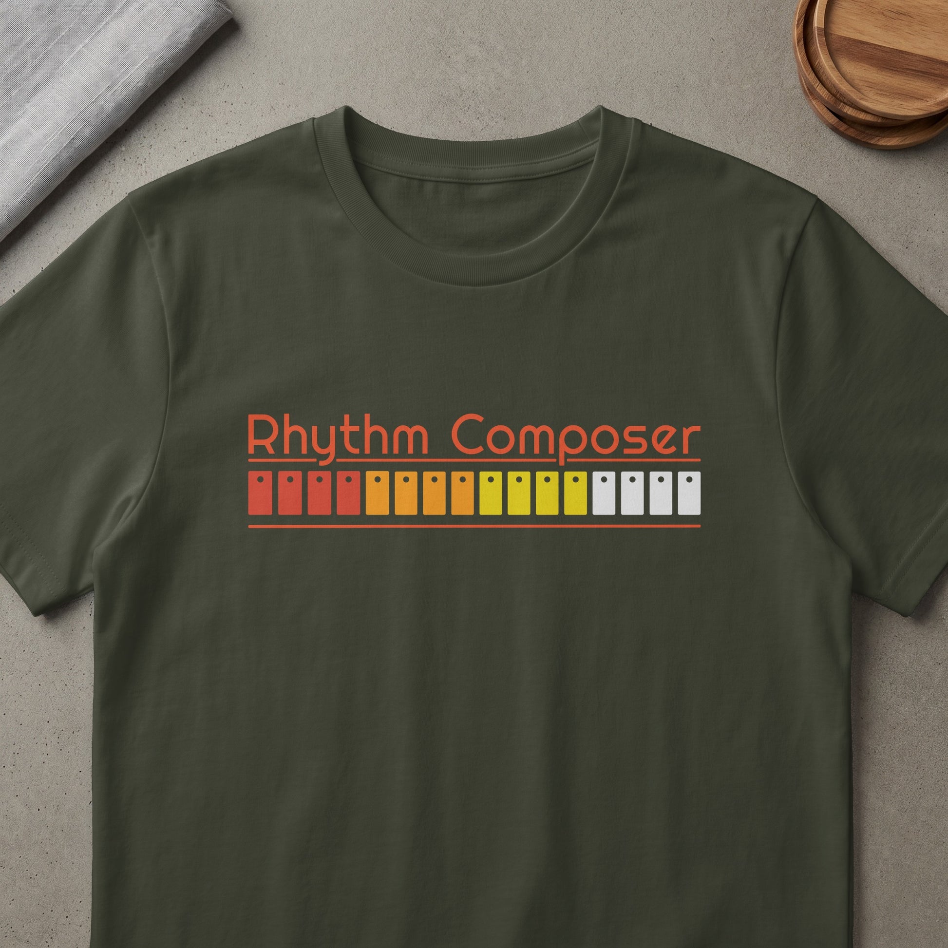 Olive green t-shirt with orange "Rhythm Composer" text and colorful beat step sequencer graphic.