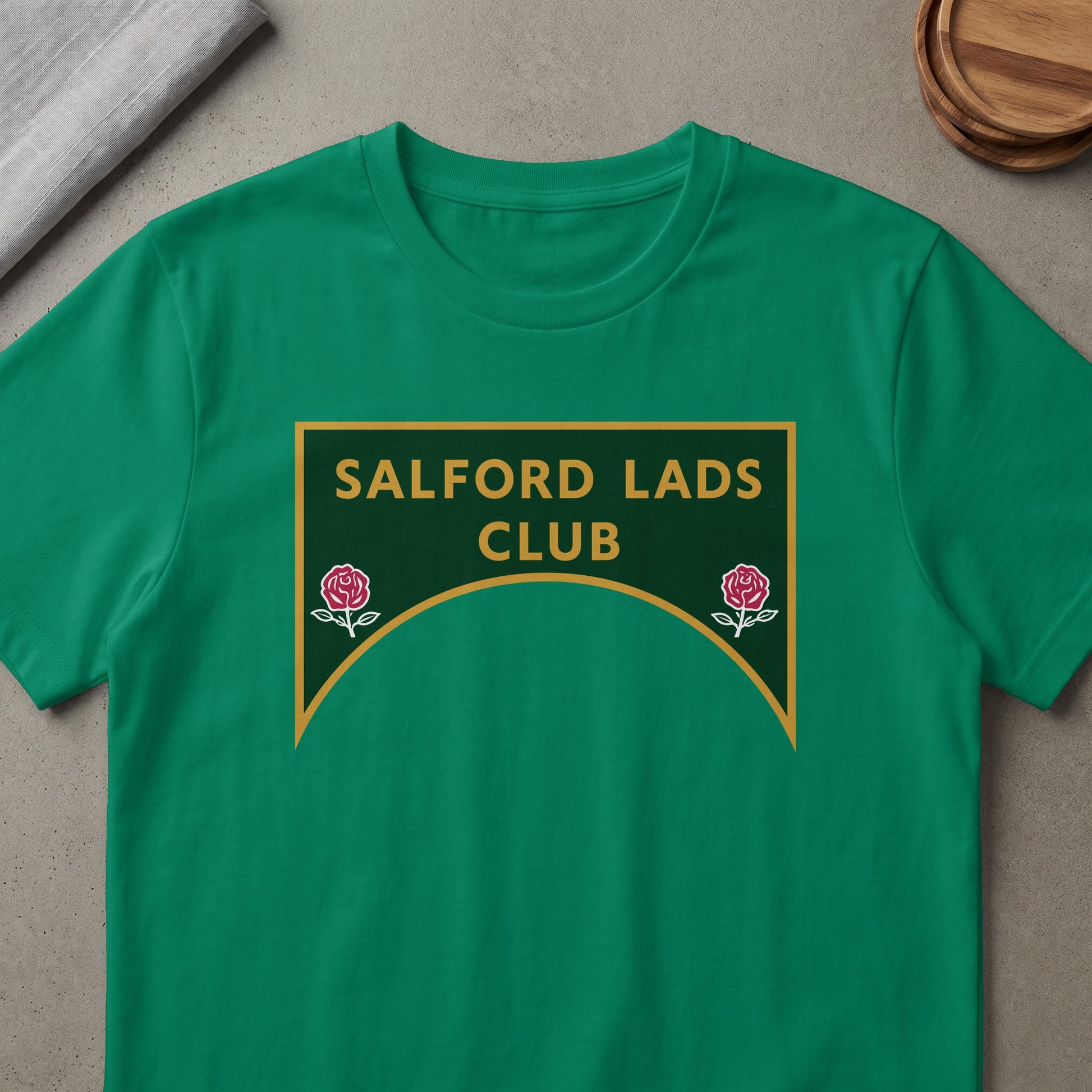 Green t-shirt with Salford Lads Club logo and two red roses.