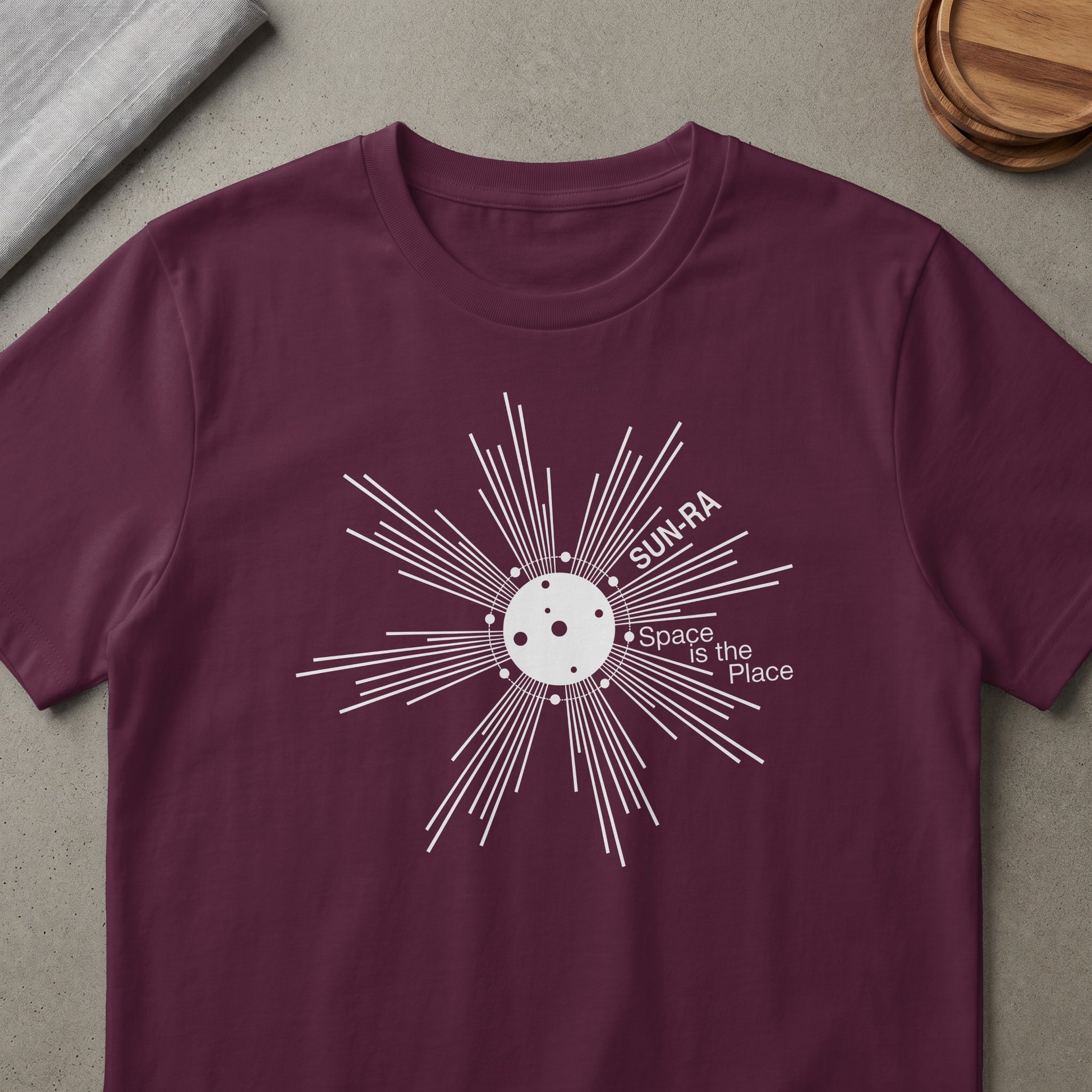 Maroon t-shirt with white Sun-Ra graphic and text "Space is the Place".
