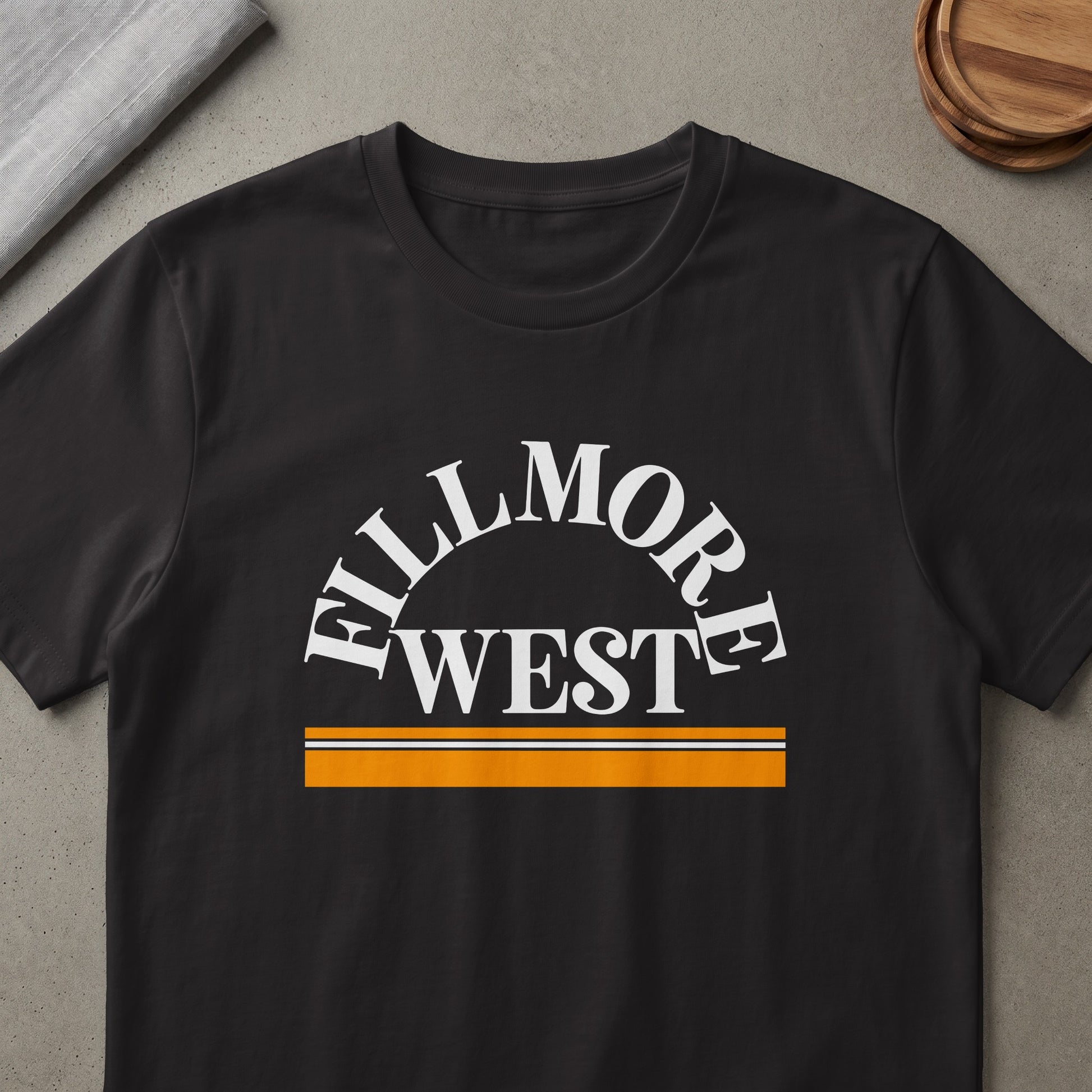 Black t-shirt with white "FILLMORE WEST" text and orange and white stripes.