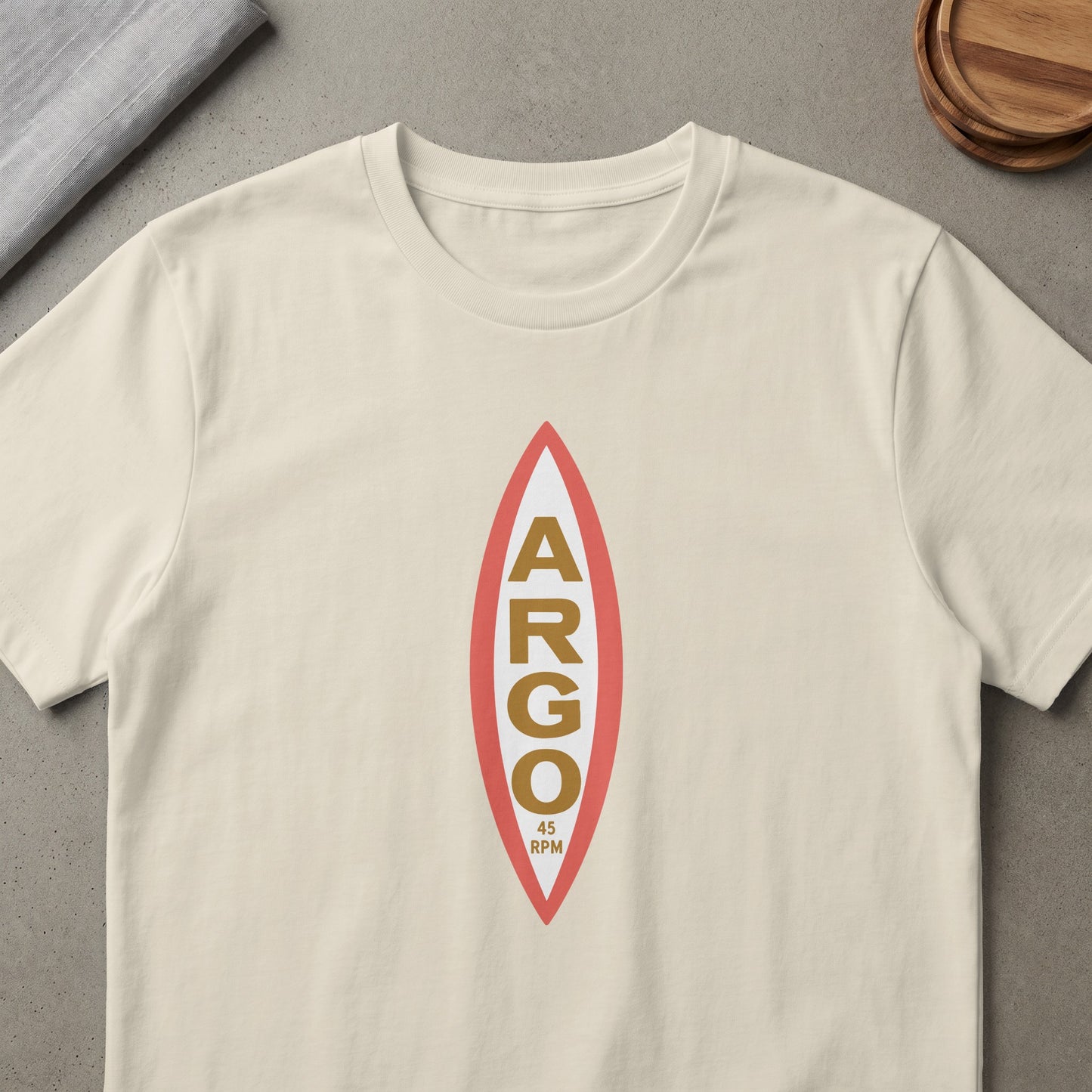 Cream t-shirt with a burgundy and white oval graphic with gold text "ARGO" and "45 RPM".