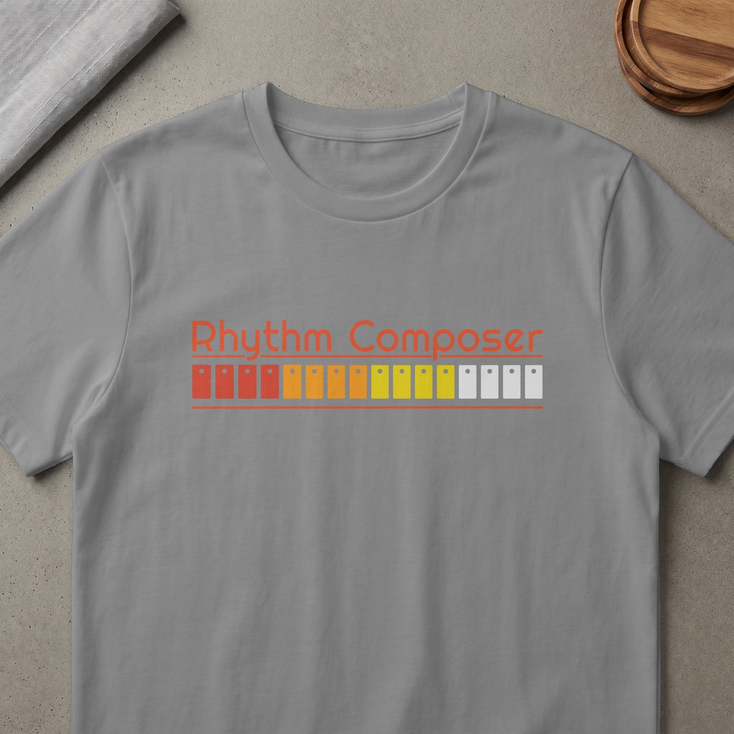 Grey t-shirt with "Rhythm Composer" text and color bars.