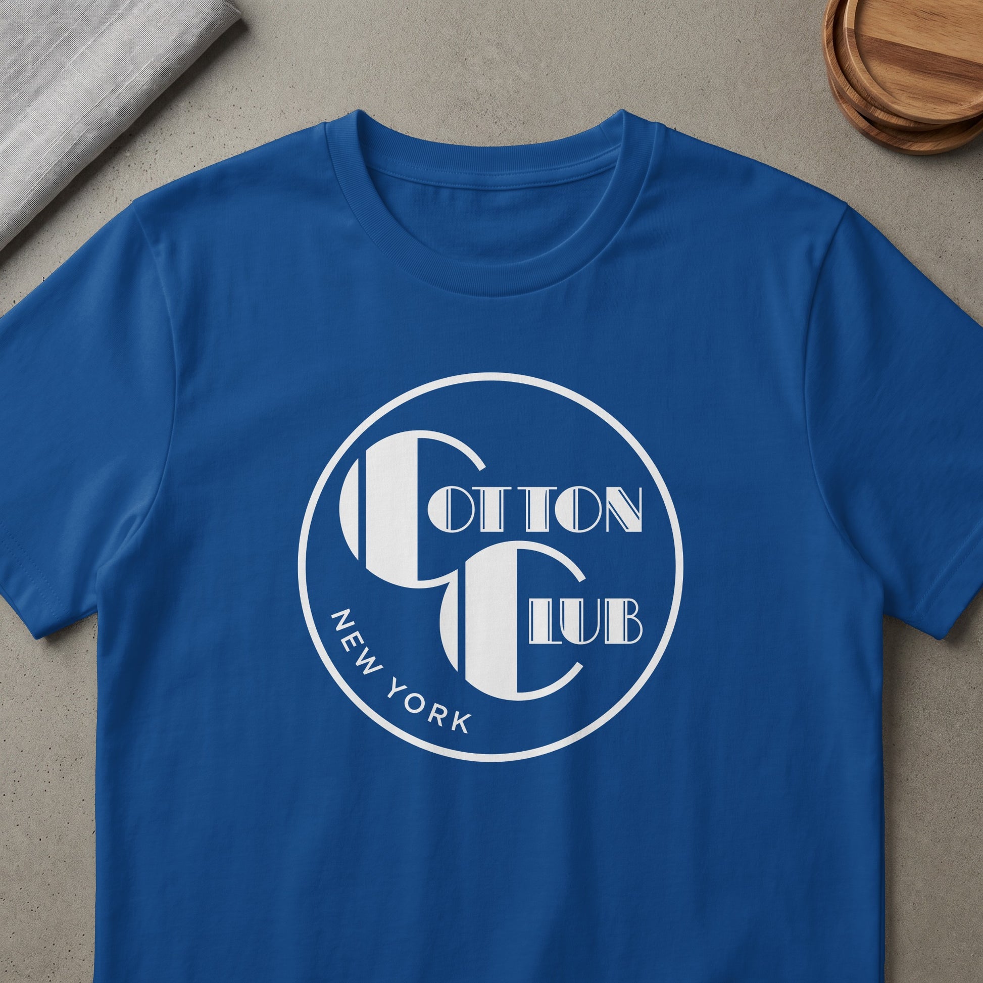 Blue t-shirt with white Cotton Club New York logo in a circle.