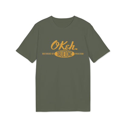 Green t-shirt with yellow "Okeh Recorded by True Tone Process" graphic.