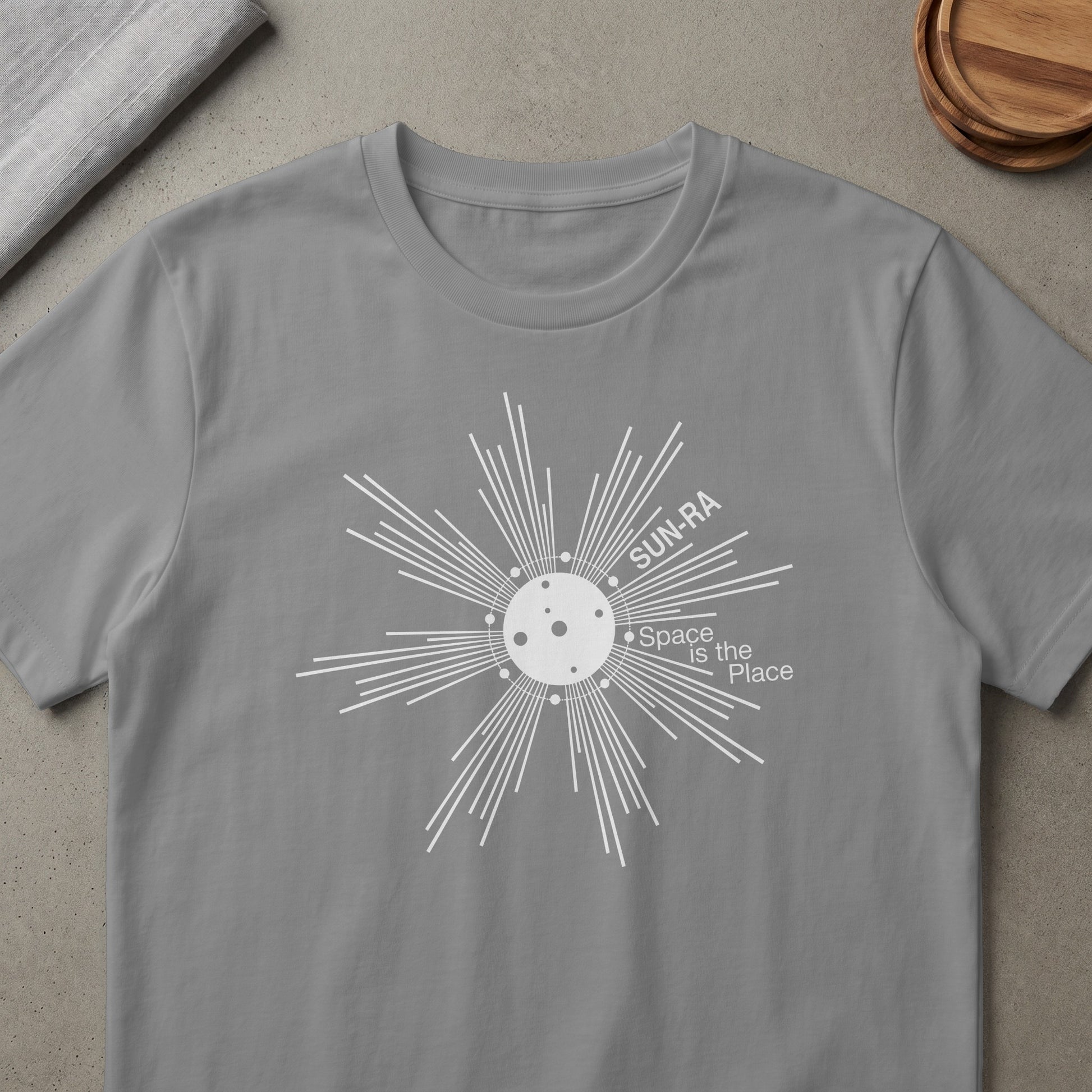 Gray t-shirt with a white sun design that reads "SUN-RA Space is the Place"