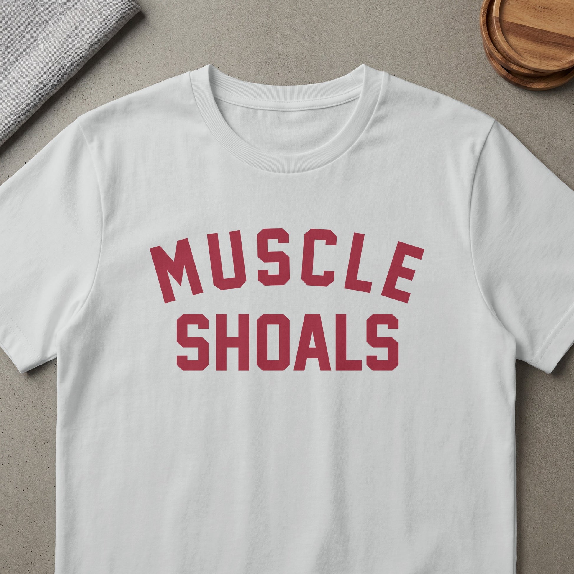 White t-shirt with red "MUSCLE SHOALS" text in collegiate font