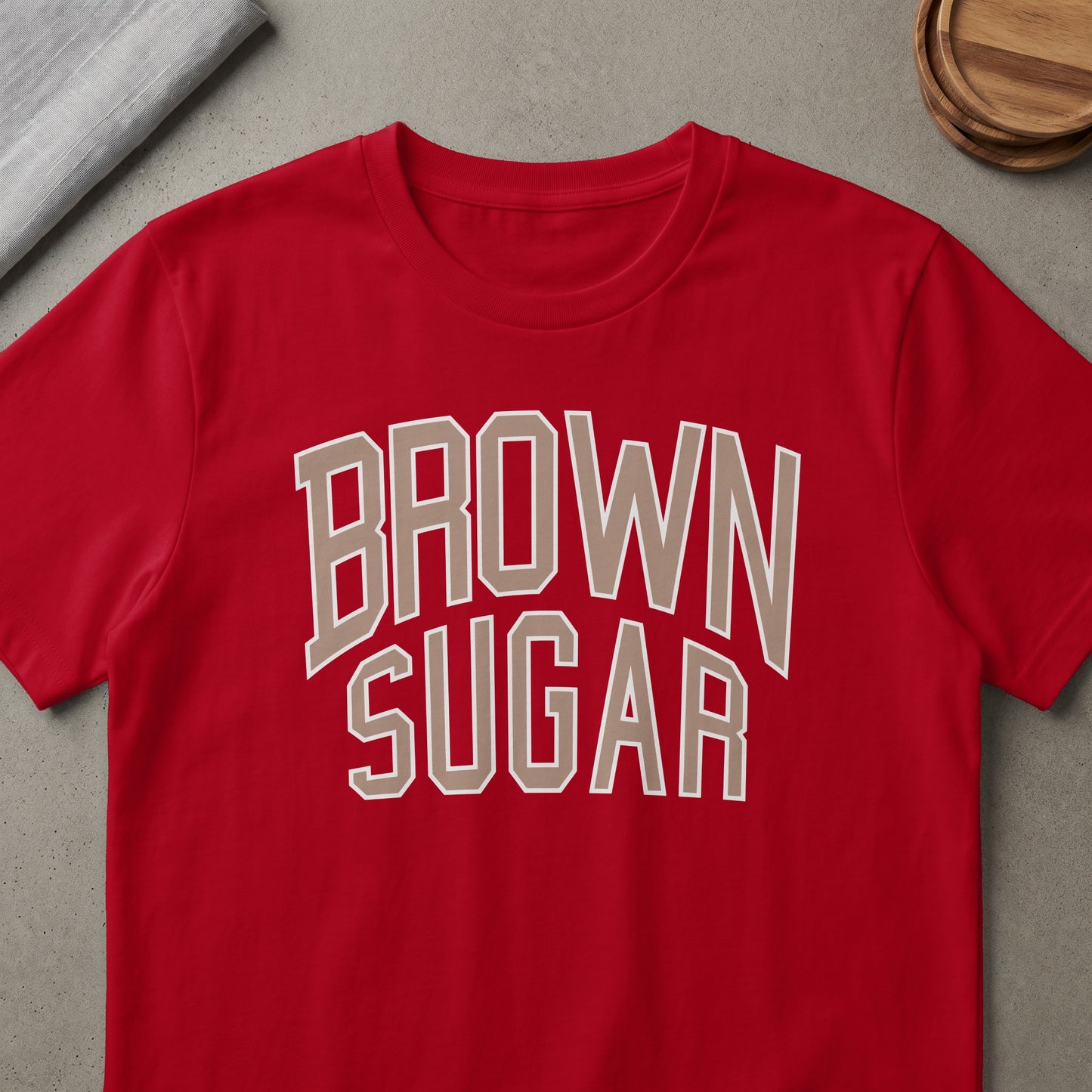 Red t-shirt with "BROWN SUGAR" text in beige outline.