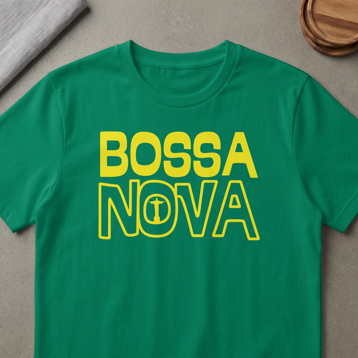 Green t-shirt with yellow text reading "BOSSA NOVA" and a silhouette of Christ the Redeemer.