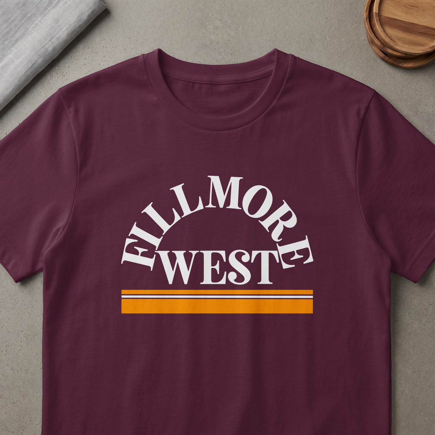 Maroon t-shirt with white "Fillmore West" text and orange and white stripes.